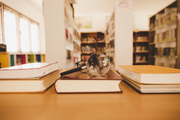 book-library-with-old-open-textbook-stack-piles-literature-text-archive-reading-desk